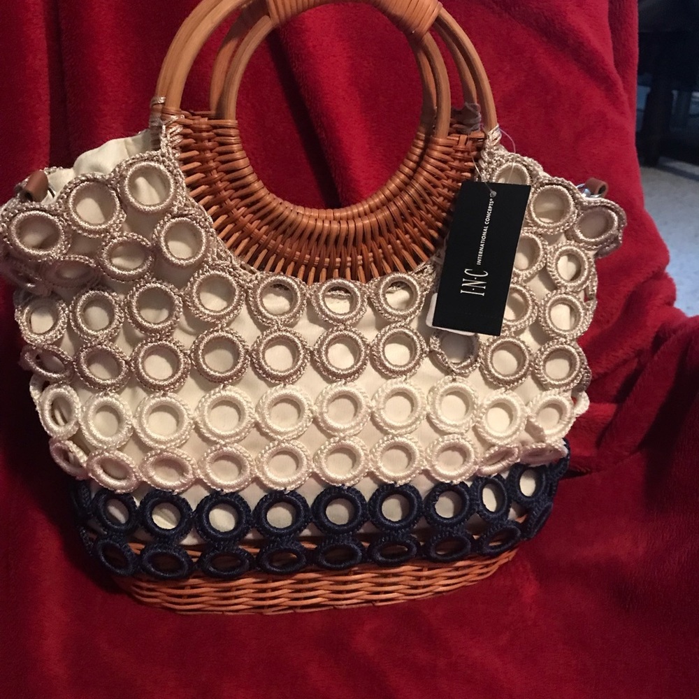 Inc straw purse with detachable shoulder strap.